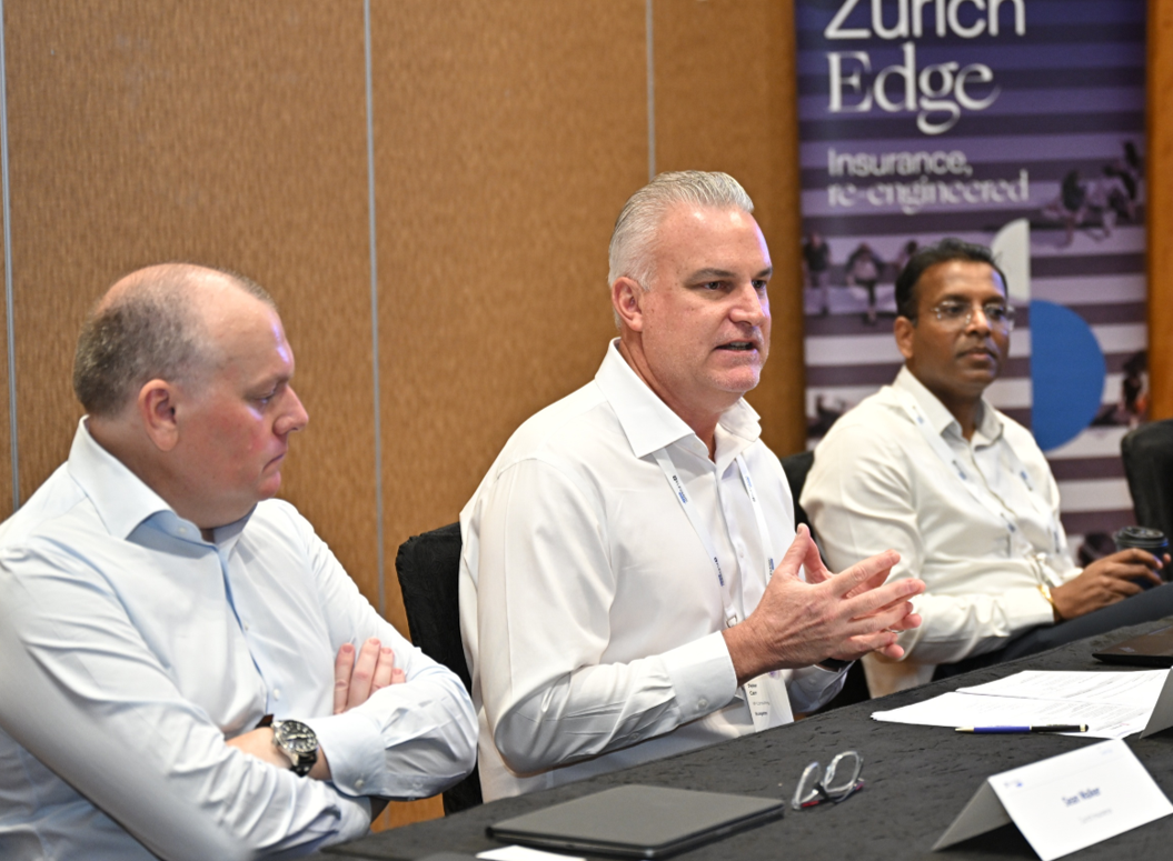 Peter Carr speaking on an executive panel